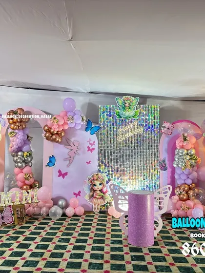 A fairy theme decoration for Swamini's first birthday. This setup features a shimmer wall, multiple backdrops, and several fairy character cutouts.
