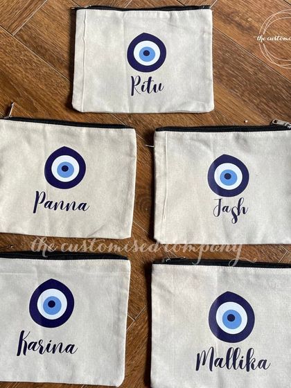 Keep worries at bay with our evil eye travel pouches. These canvas pouches are personalized with a name, making them a great way to carry positive vibes and stay organized on the go.