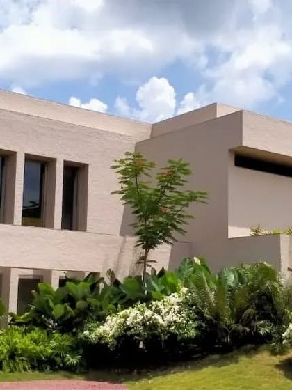 A view of the "House in the Hills" showcasing its clean lines and integration with the surrounding garden. The architecture respects the natural context while providing modern living spaces.