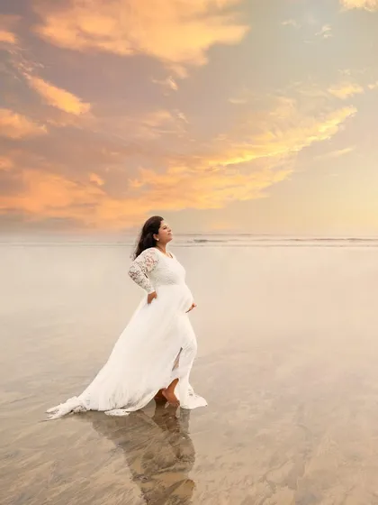 There is a unique power in a mother standing strong, waiting to meet her baby. This outdoor portrait, taken during the golden hour at a Mumbai beach, captures that serene and powerful solitude against a breathtaking sunset.