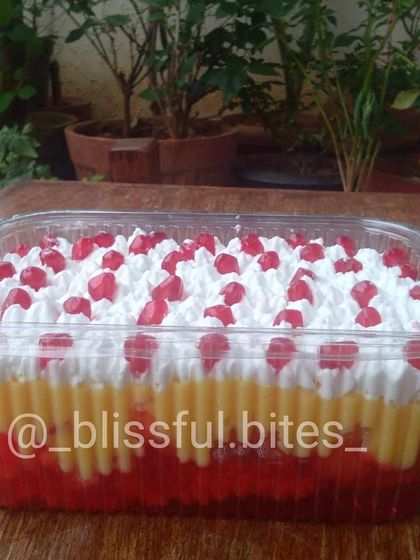 A family-sized portion of my classic fruit trifle, with its colourful layers of jelly and custard, ready for a party.