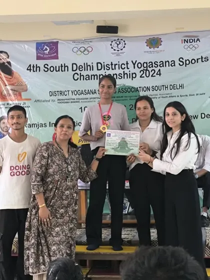 My student Deepa on the podium after winning a gold medal in artistic yoga at the district level championship.