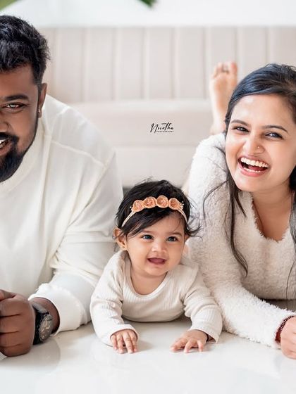 A relaxed and joyful family portrait on the floor.