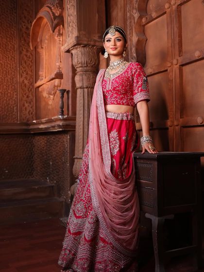 A full view of this royal bridal look. The makeup is perfectly balanced with the elaborate jewellery and detailed lehenga, creating a cohesive and breathtaking vision of elegance.