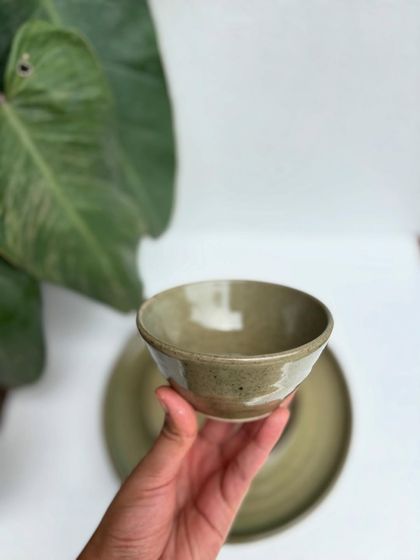 Holding our Green Celadon bowl. You can feel the quality and care that goes into each piece, from the smooth finish to the comfortable weight in your hand.