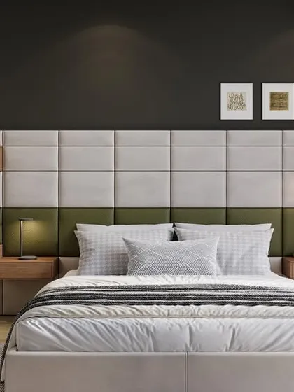 This bedroom design incorporates a functional workspace directly into the headboard. The combination of olive green and grey upholstery, along with the dark accent wall, creates a sophisticated and modern look that is perfect for a multifunctional space.