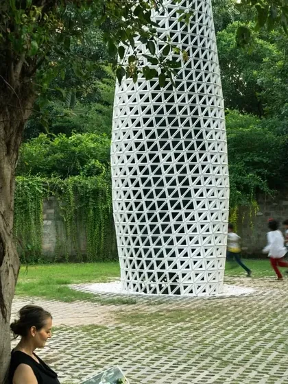A person enjoys a quiet moment near the VERTO tower. Our design aims to create spaces of respite and well-being within busy cities.