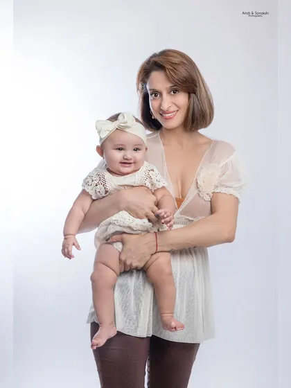 It's so special to have a mini-me. This portrait captures the sweet connection between a mother and her baby girl during her six-month milestone shoot.