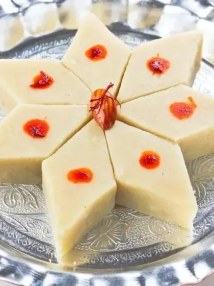 My Kaju Barfi, beautifully arranged in a star shape. The saffron and almond garnish makes it a visually stunning addition to any festive platter.