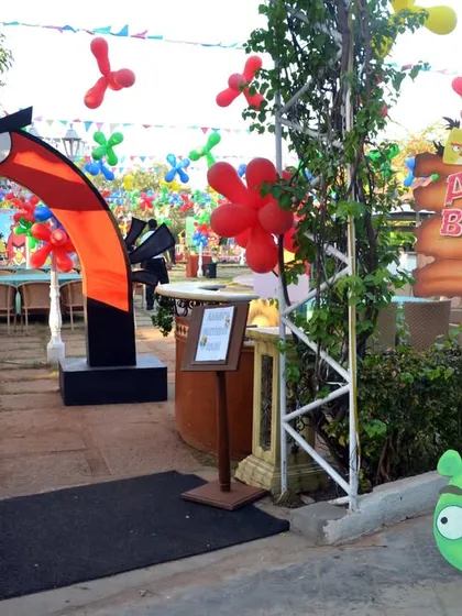 The entrance arch to "Aarav's Birthday Bash," an Angry Birds themed party, complete with character props to welcome guests.