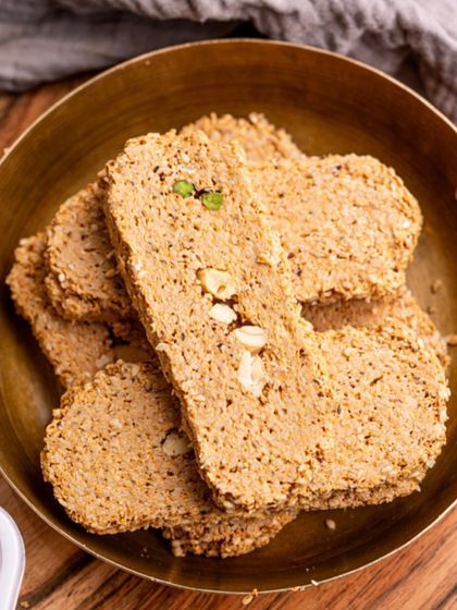 A close-up of my heart-shaped Gajak in a brass bowl. This traditional winter sweet is perfect for celebrating Makar Sankranti with love and warmth.