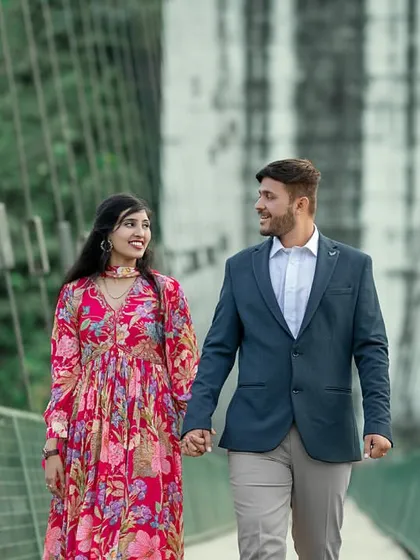 A happy, smiling walk across a suspension bridge. This candid shot is full of joy and movement, perfectly capturing the excitement of exploring a new place together.