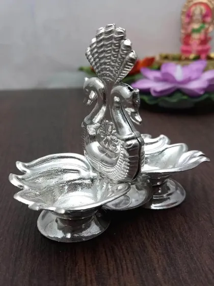 A German silver kumkum daani with a Hamsa (swan) and Kamal (lotus) design, combining multiple auspicious elements.
