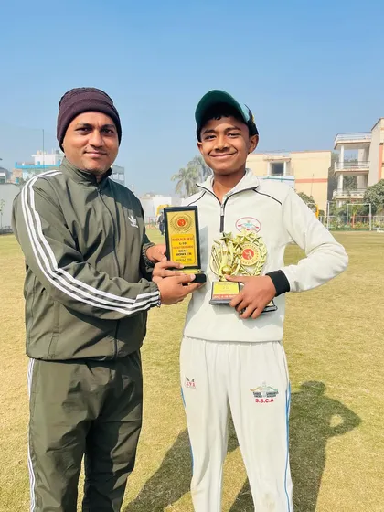 Dhruv Jangra, the Man of the Tournament, with his awards.