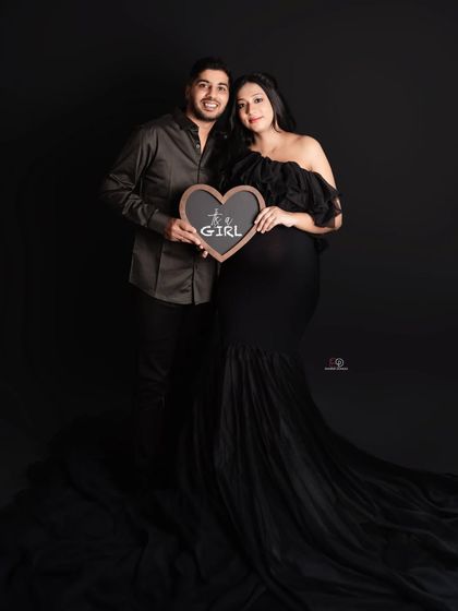 A classic gender reveal! This couple chose a beautiful black gown and a simple sign to announce they are expecting a baby girl.