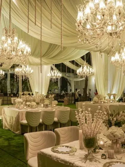 We created a dreamscape of ivory and gold for this luxurious reception. The space was filled with flowing drapery, dozens of crystal chandeliers, and all-white floral arrangements, crafting an atmosphere of pure elegance and romance.