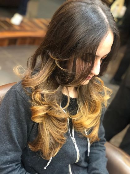 This image shows how the golden ombre frames the face, with lighter pieces starting around the chin. It's a flattering technique that draws attention to the client's features.