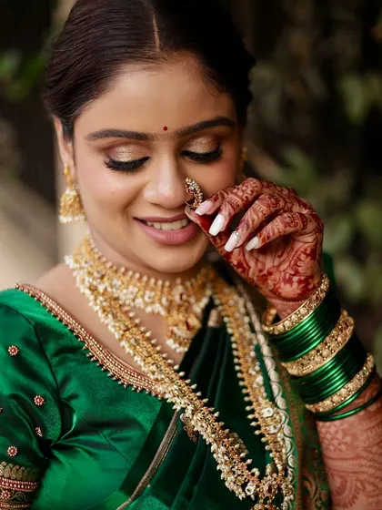 A close-up of our beautiful Maharashtrian bride, showing her subtle glittery eye makeup and the traditional nath, which completes the look.