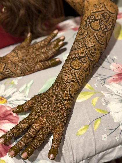 Both arms are shown here, with a consistent and beautifully executed bridal henna design.
