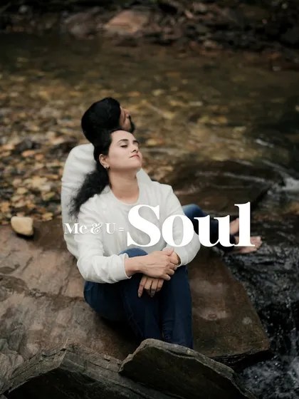 A serene and soulful portrait of the couple relaxing by a stream. This image captures a moment of peace and connection, showing the quieter side of their love story.