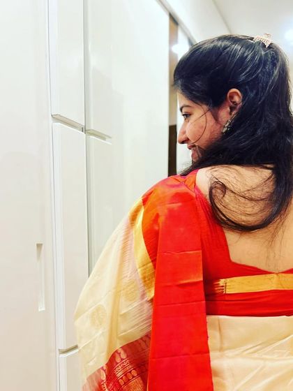 The elegance of a saree from the back. Every detail, from the drape of the fabric to the posture, contributes to the beauty of a performance.