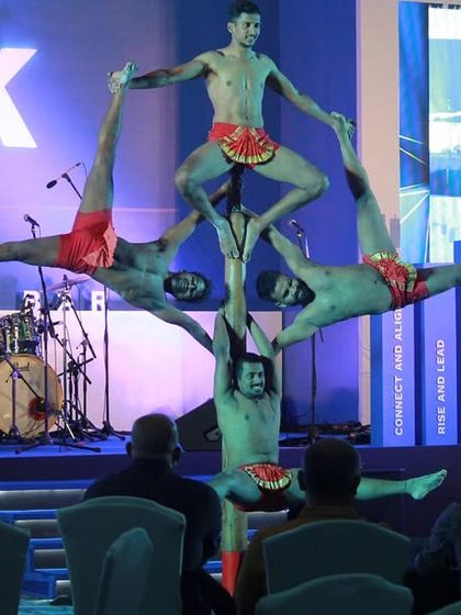 Our artists creating a complex, multi-level formation on the pole during a corporate event for AAK. These performances are a great way to bring the energy and discipline of Mallakhamb to a wider audience.
