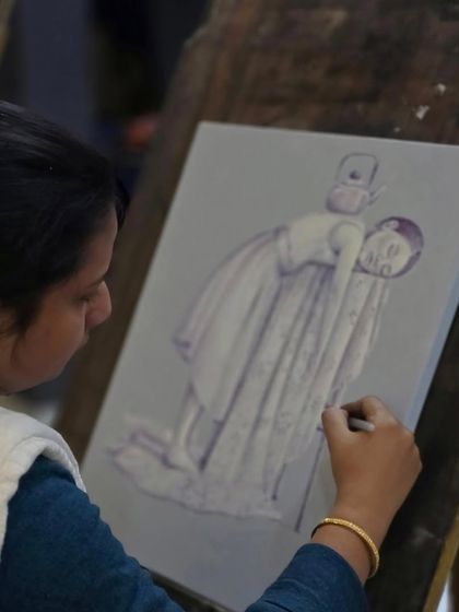 An over-the-shoulder view of a student creating her surreal artwork, showcasing the calm and focused atmosphere of our studio.