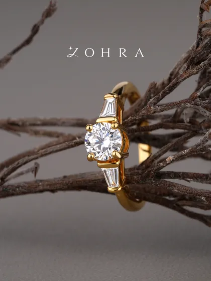 A promise of forever should be as unique as your love story. This bespoke engagement ring features a brilliant-cut centre diamond, flanked by elegant baguette diamonds on a polished 18k gold band. I work with each client to ensure every element, from the diamond's cut to the band's design, perfectly captures their vision.
