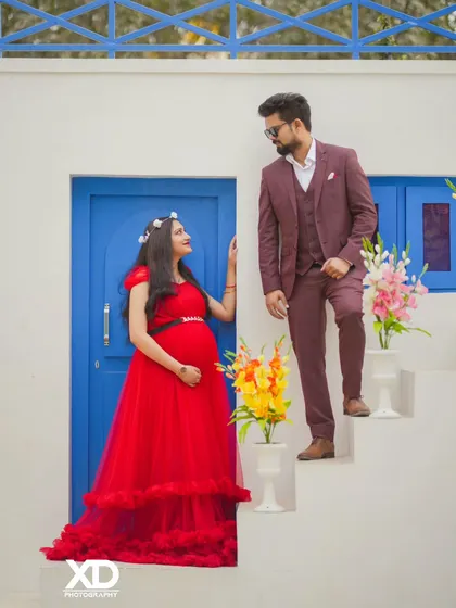 A romantic pose with the couple looking at each other on a stylish white staircase set.