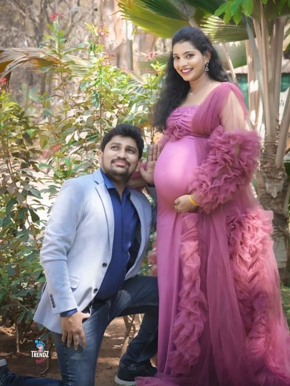 A playful and classic pose where the dad-to-be listens to the baby bump. This is a fun way to show his connection and anticipation during an outdoor maternity session.