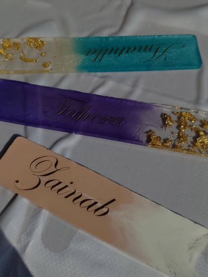 Another view of the three custom name bookmarks, highlighting the elegant script and the way the colors blend together.