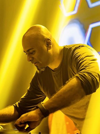 A focused shot of me at the decks, surrounded by yellow lights.