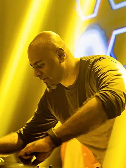 A focused shot of me at the decks, surrounded by yellow lights.