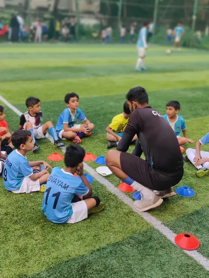Our coach sits with the kids for a tactical talk, ensuring they understand the 'why' behind the drills.