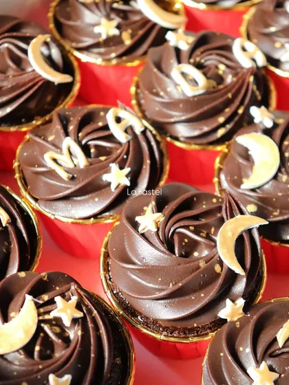 A close-up of the Ramadan-themed cupcakes, highlighting the gold letters and celestial decorations.