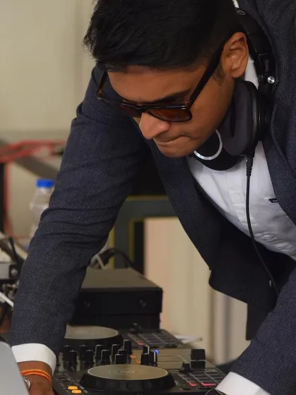 I adapt my style to fit the event, including more formal corporate parties and wedding receptions. Here I am, focused on curating the perfect sophisticated soundtrack for a private celebration.
