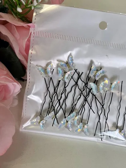 For a classic and elegant look, you can't go wrong with these white iridescent butterfly U-pins. They look stunning on dark hair.