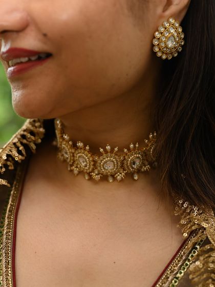A close-up of a client admiring the intricate details of the Noor Choker. Seeing the craftsmanship up close is an essential part of the selection process.
