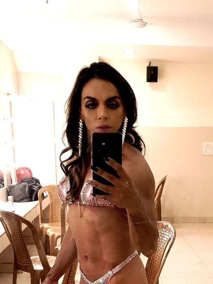 Backstage moments are filled with focus. Here I am, ready to present the physique I've worked months to build.