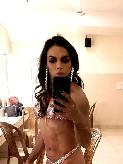 Backstage moments are filled with focus. Here I am, ready to present the physique I've worked months to build.