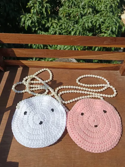 Adorable round sling purses with cute faces and pearl straps. I can make these in a variety of colors for bulk orders.