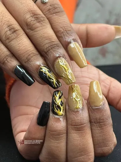 An edgy and modern design combining solid black, a neutral tan, and abstract black nails with a raised gold texture that looks like molten metal.