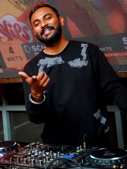 A gesture to the crowd, acknowledging the vibe. It's a two-way street; I feed off their energy, and they feed off mine.