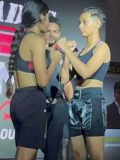 The face-off before the fight. Two fierce female competitors, including one from my team, showing respect and intensity.
