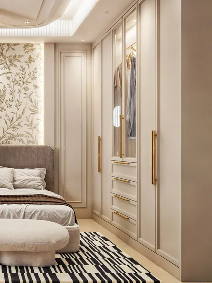 This shot focuses on the elegant wardrobe with its glass-fronted display section and brass handles.