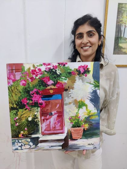 An adult student happily presents her charming painting of a floral doorway, created using acrylics on canvas. Our classes are a perfect way for adults to unwind and engage in a creative hobby.