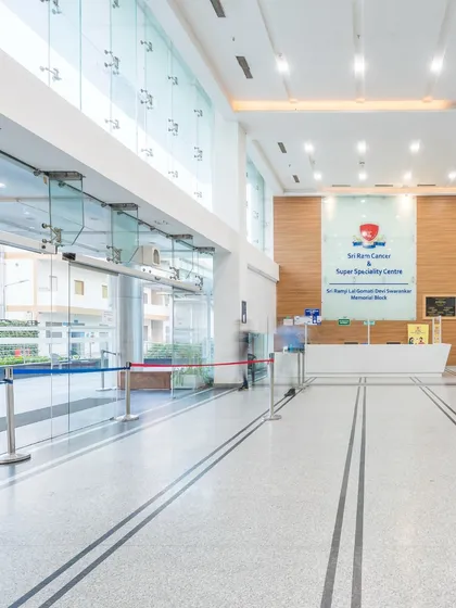This bright, glass-fronted entrance at Sri Ram Cancer Super Speciality Centre ensures that natural light floods the lobby. The design creates a transparent and welcoming first impression, easing the transition from the outside world into the clinical environment.