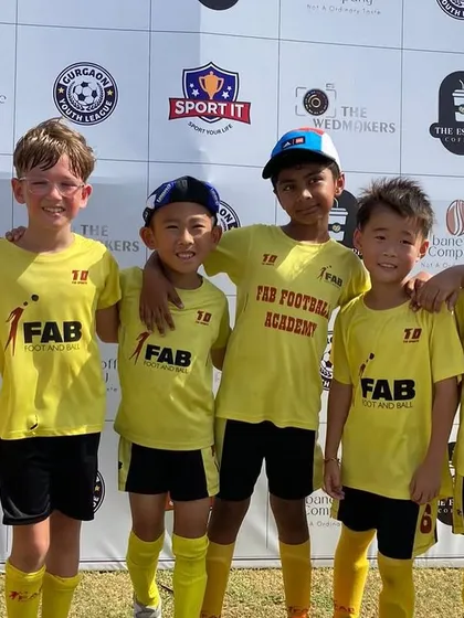 A team photo at a tournament. We instill values of teamwork, resilience, and sportsmanship in all our players.