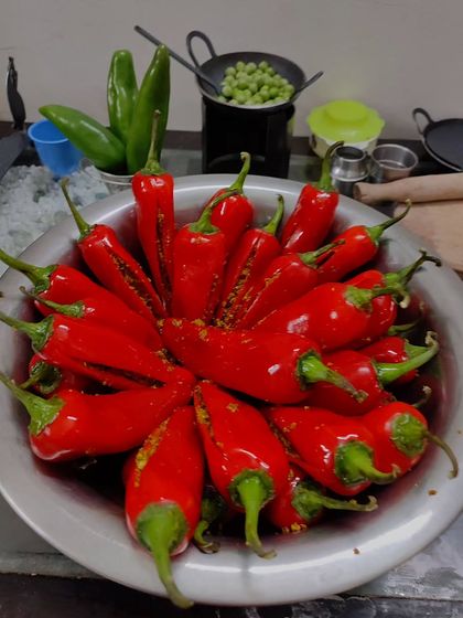 A bowl of bright red chillies, slit and filled with my special spice blend. This is the first step in making the famous Banarasi-style bharva lal mirch achar.