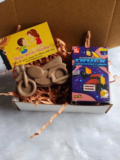 For the little brother who loves bikes, this Rakhi hamper includes a fun motorcycle-shaped soap and a small toy.